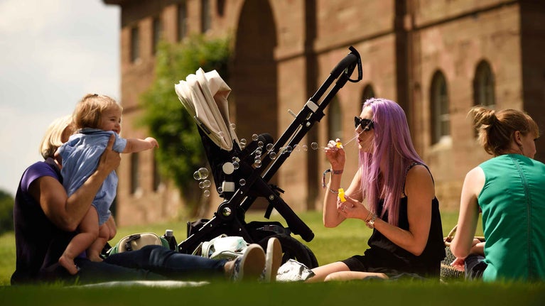 Family sat in the grounds of Berrington Hall, Herefordshire